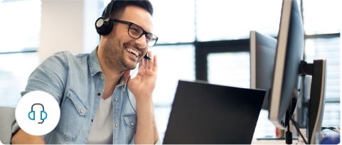 A customer service representative is on the phone talking to a customer with smile.